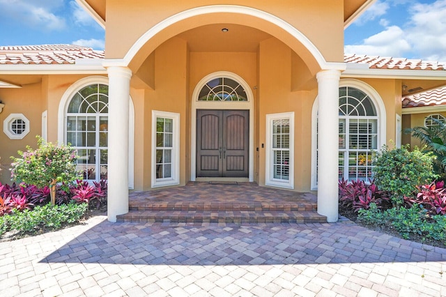 8380 Woodsmuir Dr, West Palm Beach, FL 33412 - property entrance with stucco siding and a tiled roof