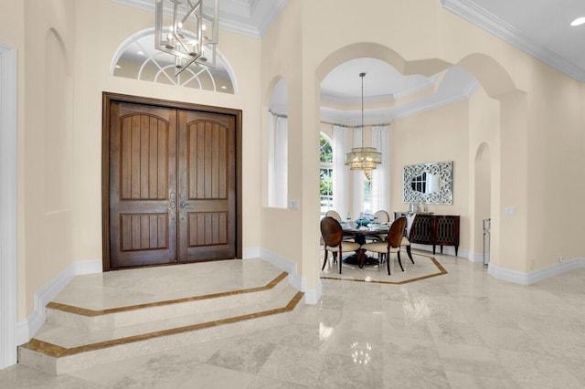 8380 Woodsmuir Dr, West Palm Beach, FL 33412 - entryway featuring a chandelier, crown molding, marble tiled floors, baseboards, and arched walkways