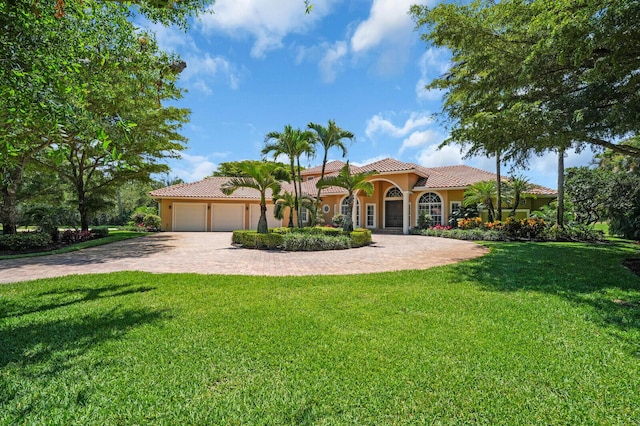 8380 Woodsmuir Dr, West Palm Beach, FL 33412 - mediterranean / spanish house featuring a tile roof, driveway, stucco siding, a garage, and a front lawn