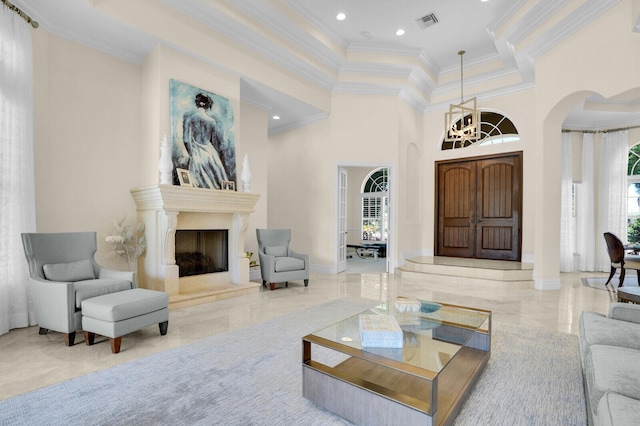 8380 Woodsmuir Dr, West Palm Beach, FL 33412 - living area featuring arched walkways, crown molding, a chandelier, healthy amount of natural light, and a premium fireplace