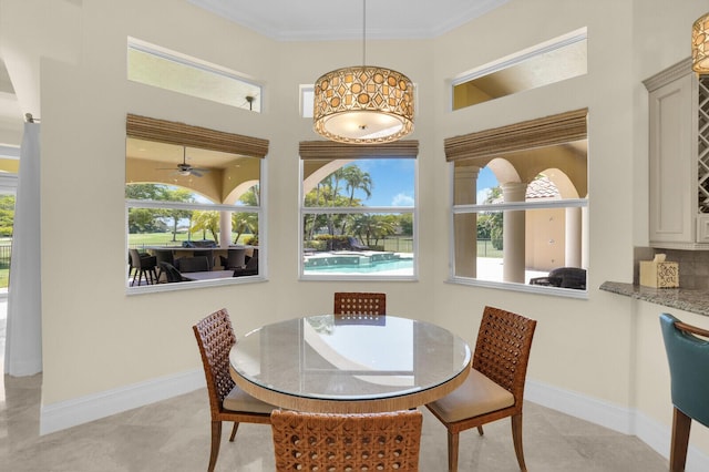 8380 Woodsmuir Dr, West Palm Beach, FL 33412 - dining area with baseboards, crown molding, ceiling fan, and a high ceiling