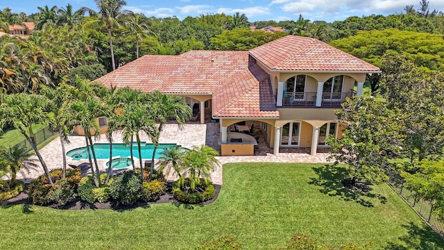 8380 Woodsmuir Dr, West Palm Beach, FL 33412 - back of property featuring stucco siding, exterior kitchen, a tiled roof, a balcony, and a patio