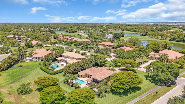 8380 Woodsmuir Dr, West Palm Beach, FL 33412 - aerial perspective of suburban area featuring a nearby body of water, a pool area, and a tree filled landscape