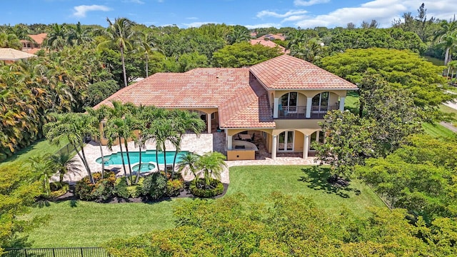 8380 Woodsmuir Dr, West Palm Beach, FL 33412 - back of property with a balcony, a tiled roof, stone siding, stucco siding, and a patio area