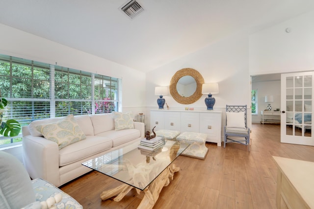 living room featuring vaulted ceiling and light wood-style flooring