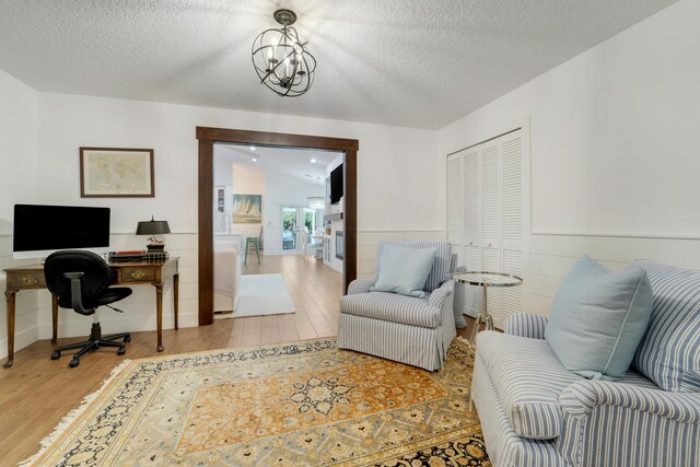 15864 78th Dr N, Palm Beach Gardens, FL 33418 - office area with wood finished floors, a textured ceiling, wainscoting, and a chandelier