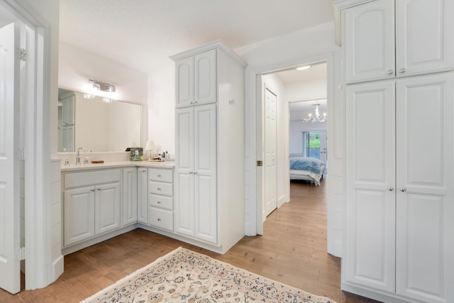 15864 78th Dr N, Palm Beach Gardens, FL 33418 - ensuite bathroom with wood finished floors, vanity, and a chandelier