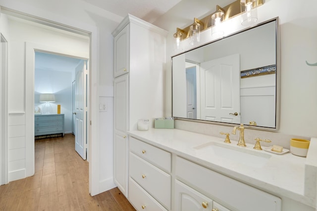 bathroom featuring wood finished floors and vanity