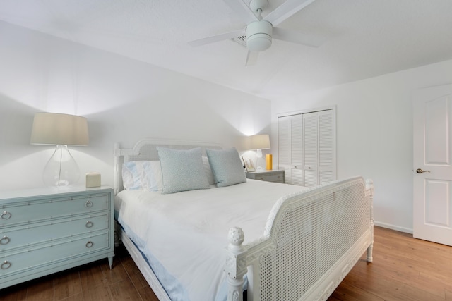 bedroom featuring a closet, wood finished floors, and ceiling fan