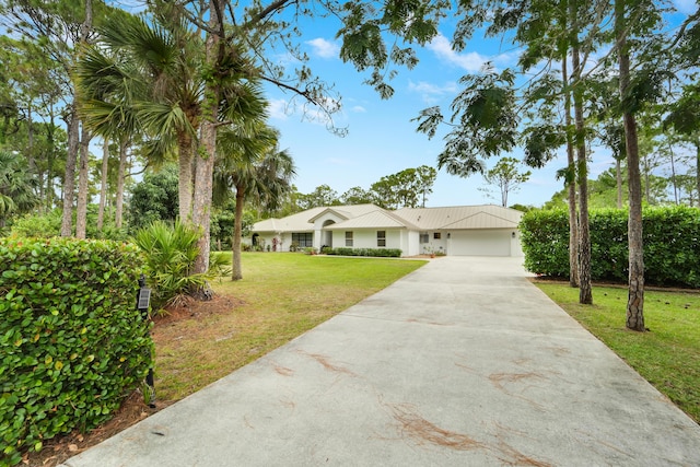 view of front of property featuring driveway, a front lawn, a garage, and stucco siding