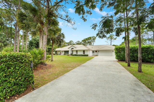 15864 78th Dr N, Palm Beach Gardens, FL 33418 - ranch-style home featuring driveway, a front yard, an attached garage, and stucco siding