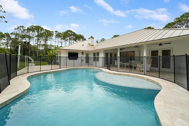 view of pool featuring french doors, ceiling fan, fence, and a patio