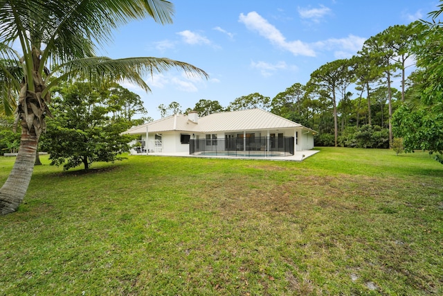 rear view of house with a yard