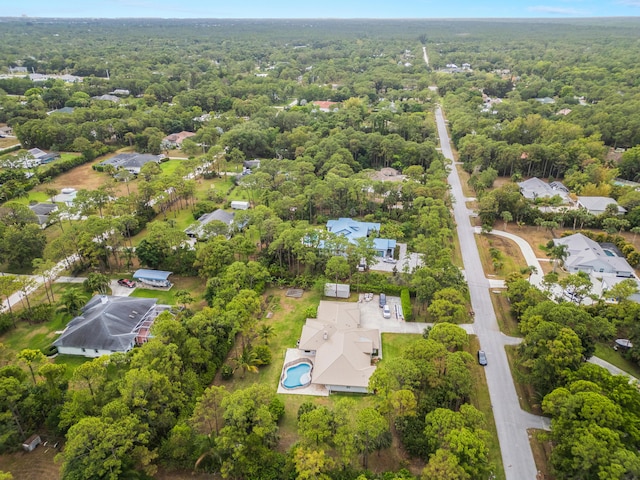 aerial overview of property's location featuring a heavily wooded area and nearby suburban area