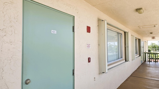 view of exterior entry with stucco siding