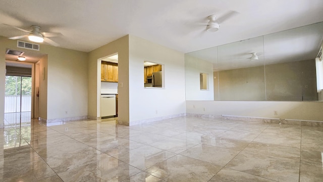 unfurnished room with ceiling fan, light marble finish floors, and baseboards