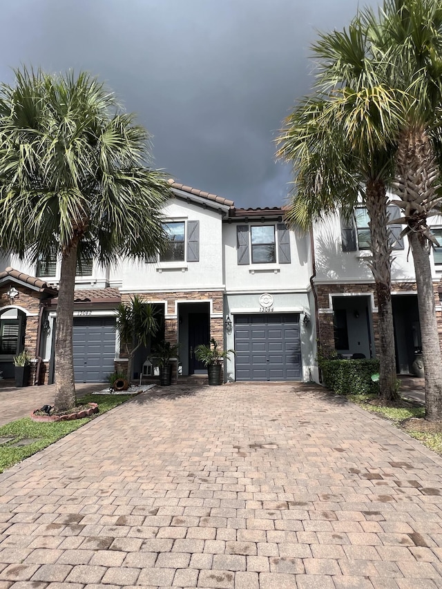 13044 Anthorne Ln, Boynton Beach, FL 33436 - multi unit property featuring decorative driveway, a garage, stucco siding, and a tile roof