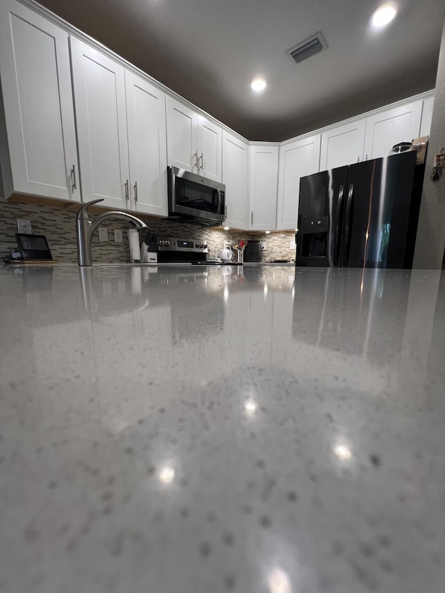 13044 Anthorne Ln, Boynton Beach, FL 33436 - kitchen with stainless steel appliances, a sink, white cabinets, light stone countertops, and recessed lighting