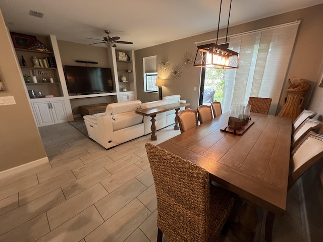 13044 Anthorne Ln, Boynton Beach, FL 33436 - dining area with ceiling fan, built in shelves, and a chandelier