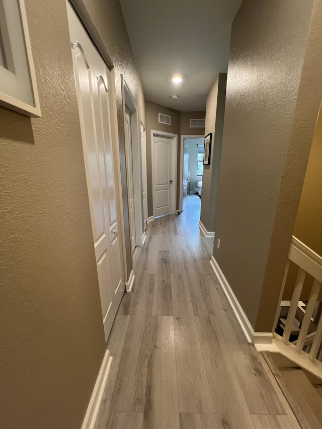 13044 Anthorne Ln, Boynton Beach, FL 33436 - corridor featuring wood finished floors, a textured wall, and baseboards