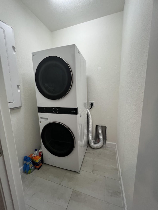13044 Anthorne Ln, Boynton Beach, FL 33436 - washroom featuring estacked washer and dryer and baseboards