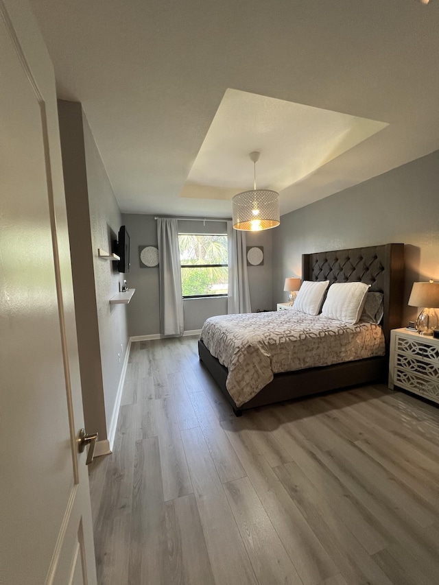 13044 Anthorne Ln, Boynton Beach, FL 33436 - bedroom with wood finished floors, baseboards, and a tray ceiling