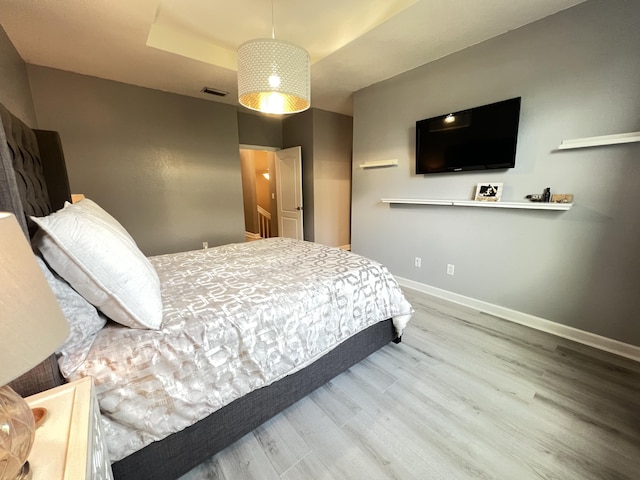 13044 Anthorne Ln, Boynton Beach, FL 33436 - bedroom featuring wood finished floors, a tray ceiling, and baseboards