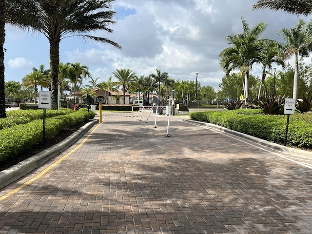 13044 Anthorne Ln, Boynton Beach, FL 33436 - view of decorative street featuring curbs, traffic signs, a gate, and a gated entry