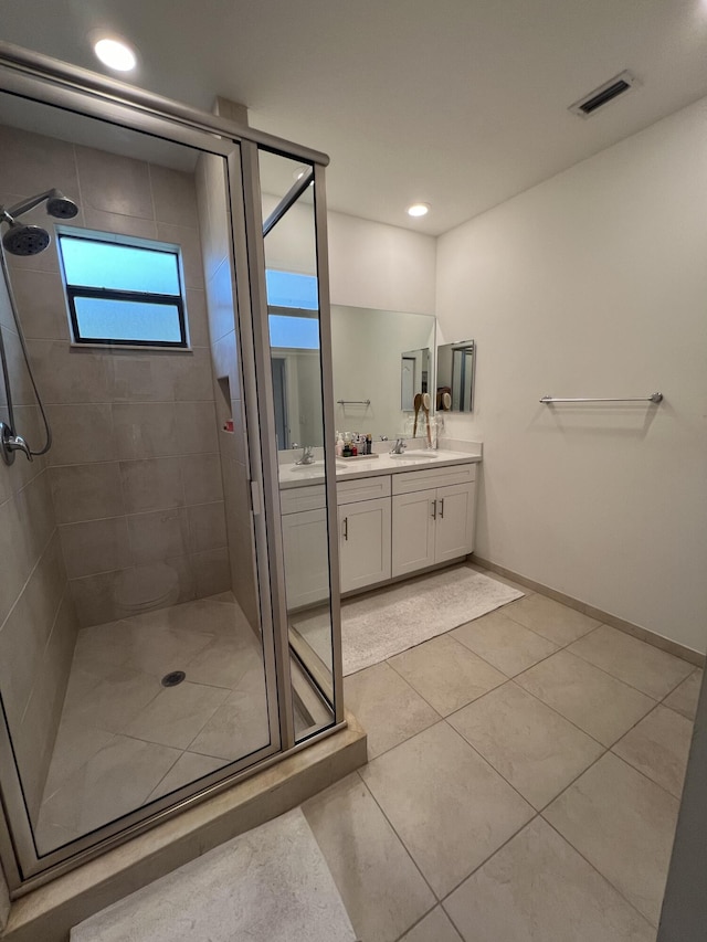13044 Anthorne Ln, Boynton Beach, FL 33436 - bathroom featuring a shower stall, double vanity, tile patterned flooring, baseboards, and recessed lighting
