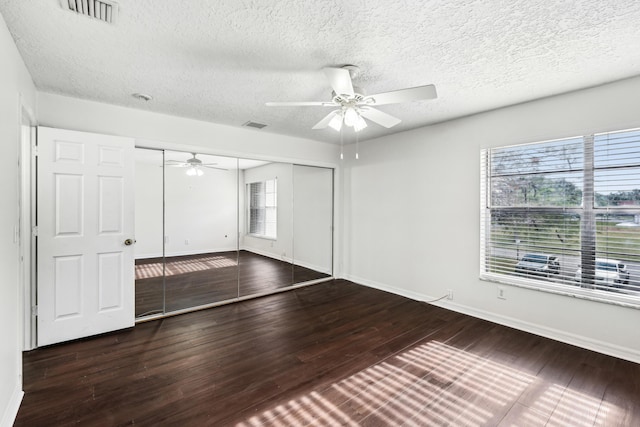 12012 Greenway Cir S Unit 206, Royal Palm Beach, FL 33411 - unfurnished bedroom featuring a textured ceiling, a closet, baseboards, wood finished floors, and a ceiling fan