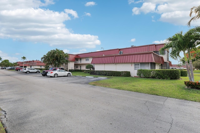 12012 Greenway Cir S Unit 206, Royal Palm Beach, FL 33411 - view of building exterior featuring uncovered parking