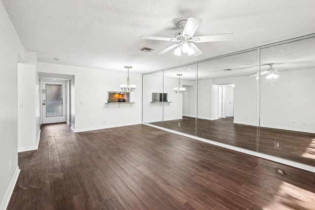 12012 Greenway Cir S Unit 206, Royal Palm Beach, FL 33411 - unfurnished living room with a ceiling fan, a chandelier, a textured ceiling, wood finished floors, and baseboards