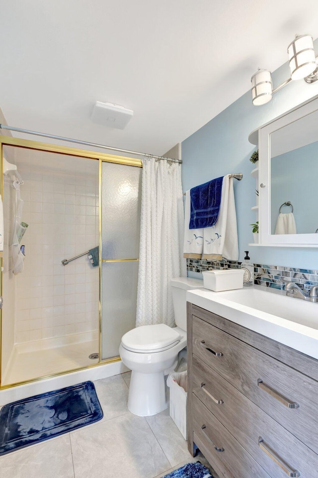 full bath featuring a stall shower, toilet, vanity, and tile patterned flooring