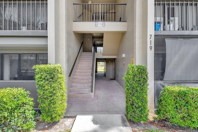 doorway to property featuring stucco siding