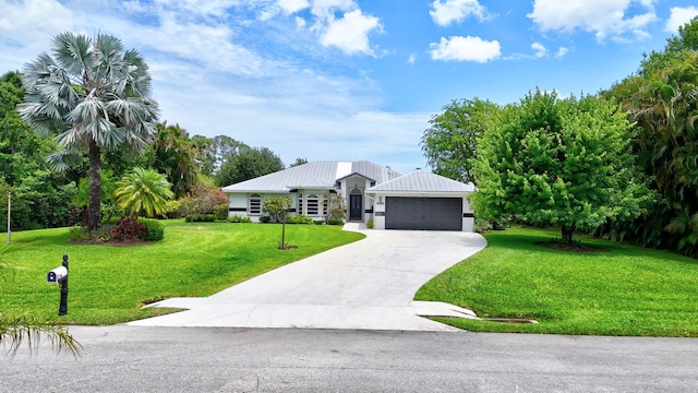 895 SE Waterside Way, Stuart, FL 34997 - view of front of property with a front yard, concrete driveway, an attached garage, and metal roof