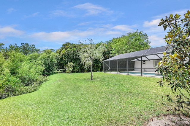 895 SE Waterside Way, Stuart, FL 34997 - view of green lawn featuring an outdoor pool and glass enclosure