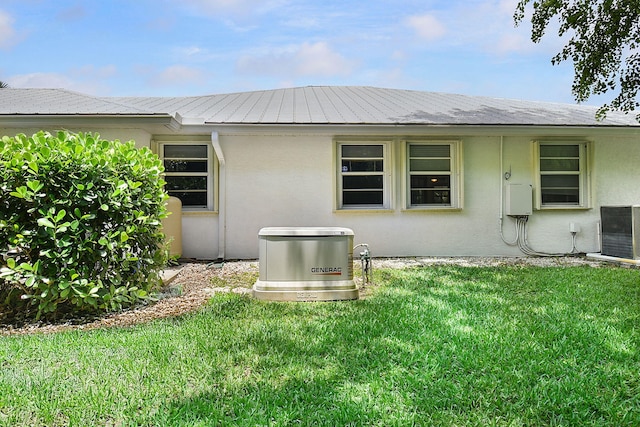 895 SE Waterside Way, Stuart, FL 34997 - back of property with stucco siding, a lawn, and central air condition unit