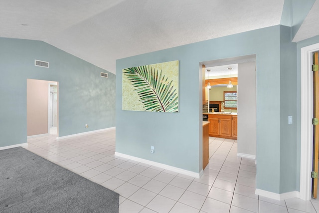 895 SE Waterside Way, Stuart, FL 34997 - spare room with lofted ceiling, light tile patterned flooring, and baseboards