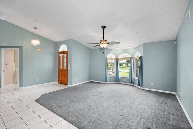 895 SE Waterside Way, Stuart, FL 34997 - spare room with vaulted ceiling, baseboards, ceiling fan, tile patterned floors, and a textured ceiling