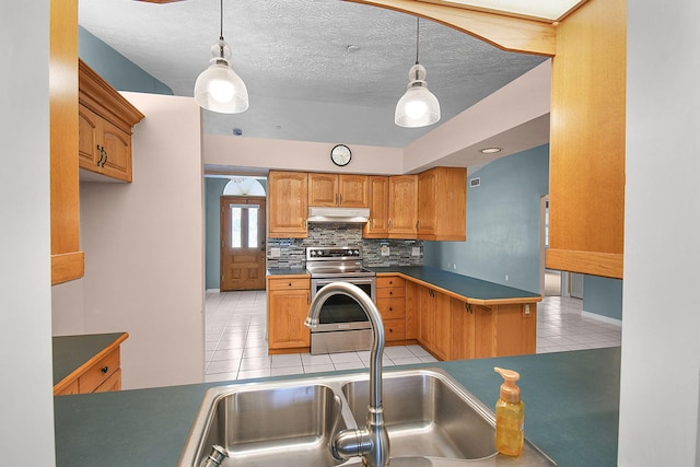 895 SE Waterside Way, Stuart, FL 34997 - kitchen with under cabinet range hood, stainless steel electric stove, light tile patterned floors, a sink, and decorative backsplash