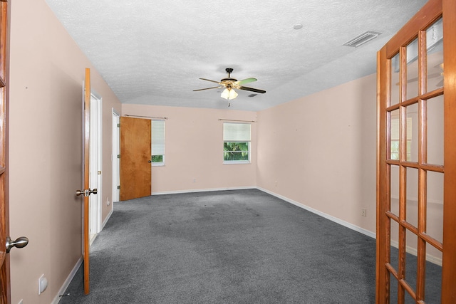 895 SE Waterside Way, Stuart, FL 34997 - unfurnished room with a ceiling fan, dark colored carpet, baseboards, and a textured ceiling