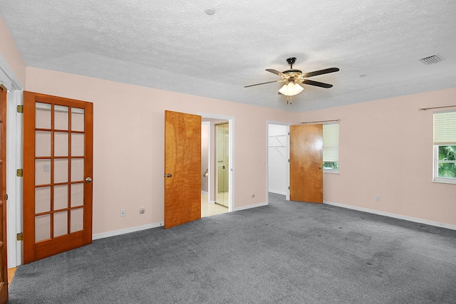895 SE Waterside Way, Stuart, FL 34997 - empty room with a ceiling fan, carpet, baseboards, and a textured ceiling