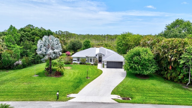 895 SE Waterside Way, Stuart, FL 34997 - view of front of home featuring an attached garage, a front lawn, and concrete driveway