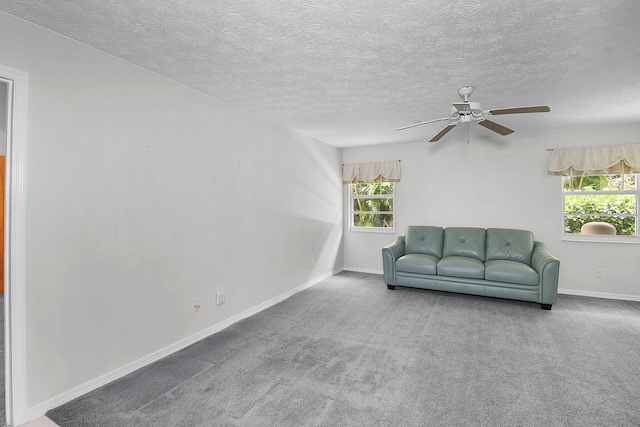 895 SE Waterside Way, Stuart, FL 34997 - living room featuring a ceiling fan, carpet floors, baseboards, and a textured ceiling