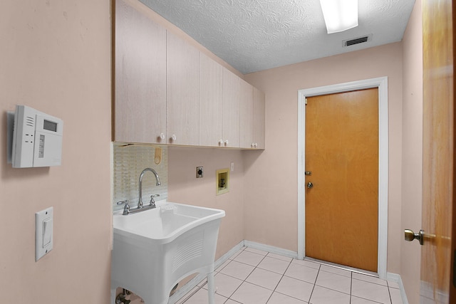 895 SE Waterside Way, Stuart, FL 34997 - washroom with cabinet space, washer hookup, electric dryer hookup, baseboards, and light tile patterned flooring