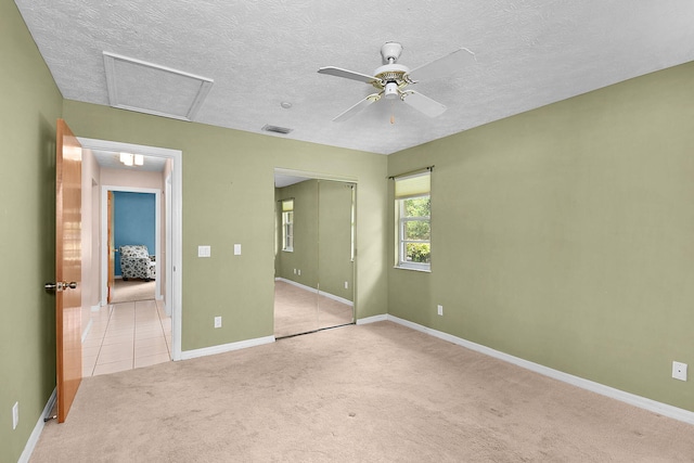 895 SE Waterside Way, Stuart, FL 34997 - unfurnished bedroom with carpet floors, attic access, a closet, baseboards, and a textured ceiling
