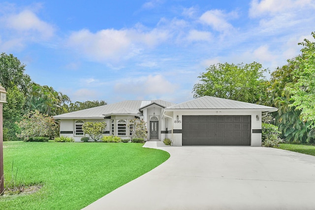 895 SE Waterside Way, Stuart, FL 34997 - view of front facade featuring a garage, stucco siding, concrete driveway, and a front lawn