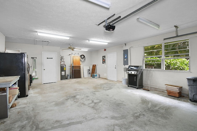 895 SE Waterside Way, Stuart, FL 34997 - garage featuring electric water heater, freestanding refrigerator, electric panel, and a garage door opener