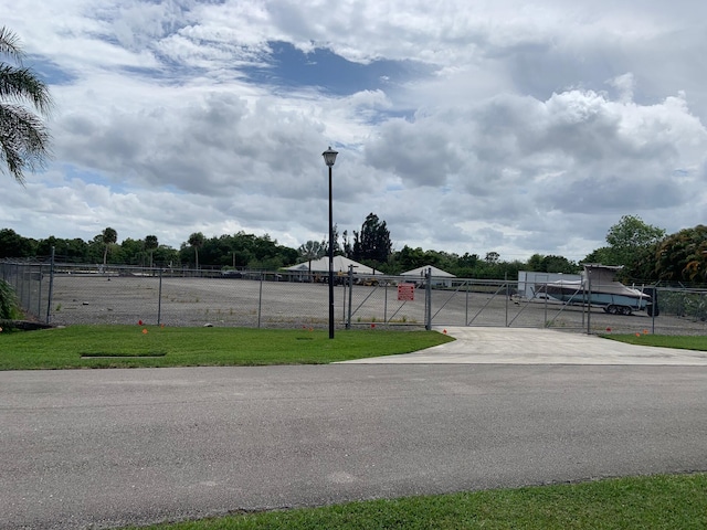 895 SE Waterside Way, Stuart, FL 34997 - view of street featuring a gate and street lighting