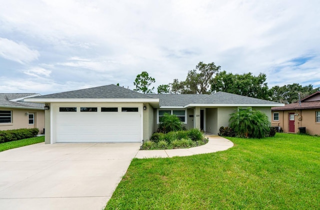 single story home featuring an attached garage, stucco siding, driveway, a front lawn, and a shingled roof